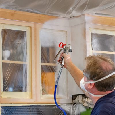 Learn how to spray paint kitchen cabinets with airless sprayers.